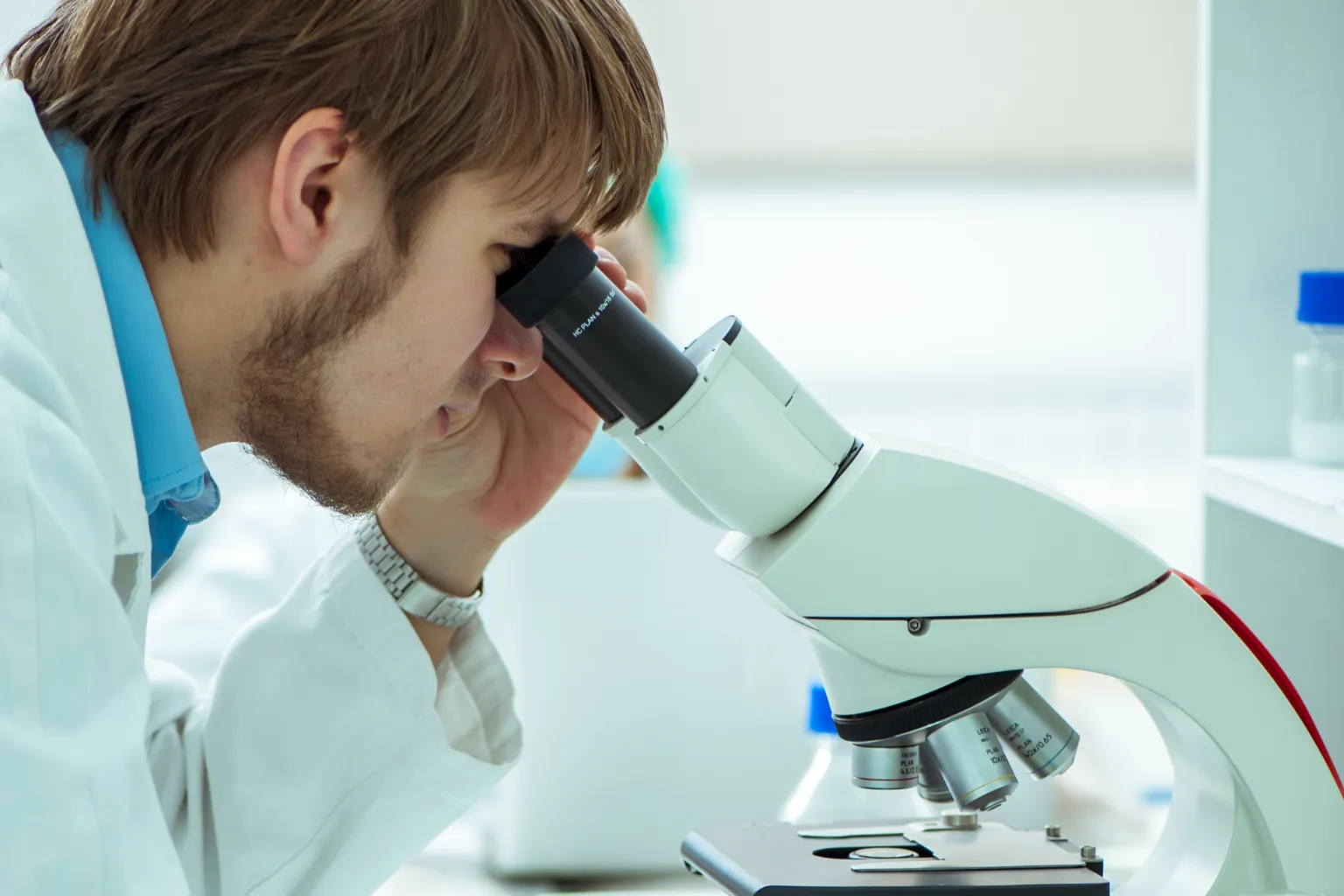 Liquim laboratory, Perth WA — scientist reviewing microfilm formulations under a microscope